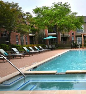 Apartments in Jersey Village Apartments in Jersey Village TX with a swimming pool and lounge chairs available for rent.