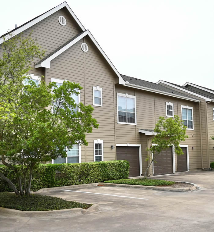Apartments in Jersey Village Spacious apartments with a parking lot and trees in Jersey Village TX.
