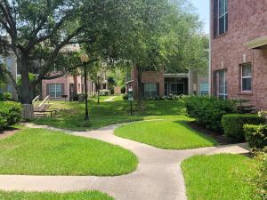 Apartments in Jersey Village, TX - Exterior Apartment Buildings with Lush Landscaping and Green Spaces  