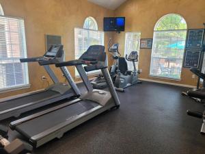 Apartments in Jersey Village, TX - Fitness Center with TV and Large Windows